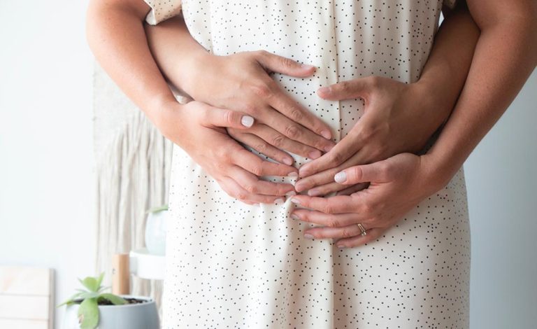 woman who experienced a miscarriage after an auto accident while her partner hugs her