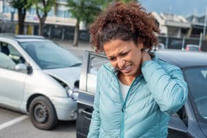 woman experiences whiplash and soft tissue injuries after a car accident