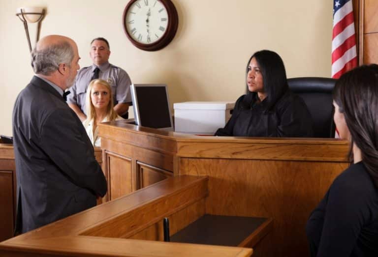 man testify in a courtroom to get a car accident settlement