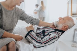 Man with bedsores lays in a nursing home